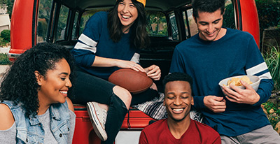 college students tailgating at football game